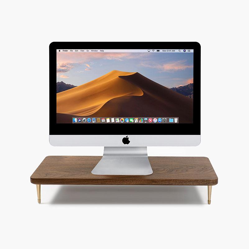 Black wooden screen riser by Noyer noir for ergonomic desk organization.