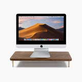 Black wooden screen riser by Noyer noir for ergonomic desk organization.