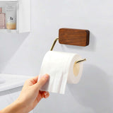 Wooden toilet paper holder with shelf in dark walnut finish, featuring a gold metal arm.