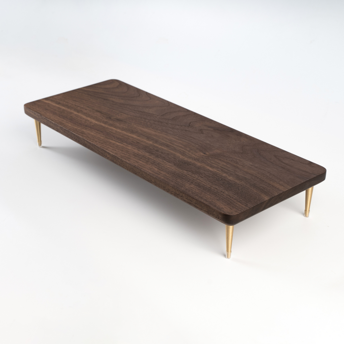 Black wooden screen riser with sleek design for optimizing desk space by Noyer noir.