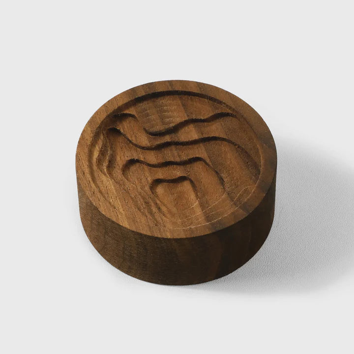 Walnut essential oil diffuser with a carved map design, by Noyer noir, ideal for wellness and aromatherapy.