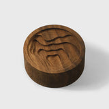 Walnut essential oil diffuser with a carved map design, by Noyer noir, ideal for wellness and aromatherapy.