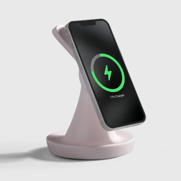 Pale pink charging stand with smartphone displaying charging status