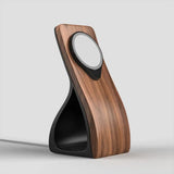Wooden charging stand for smartphones with a sleek design, featuring a round magnetic charger and a modern finish.