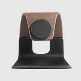 Black and wooden phone stand with modern design, featuring a curved base and center support.