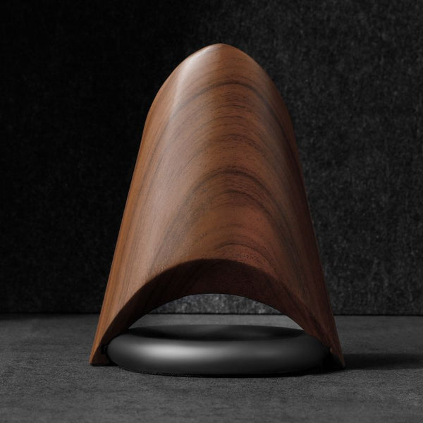 Futuristic wood charging station with MagSafe compatibility, featuring a sleek, curved design.