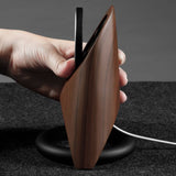 Futuristic wooden charging station with MagSafe compatibility and sleek black base.