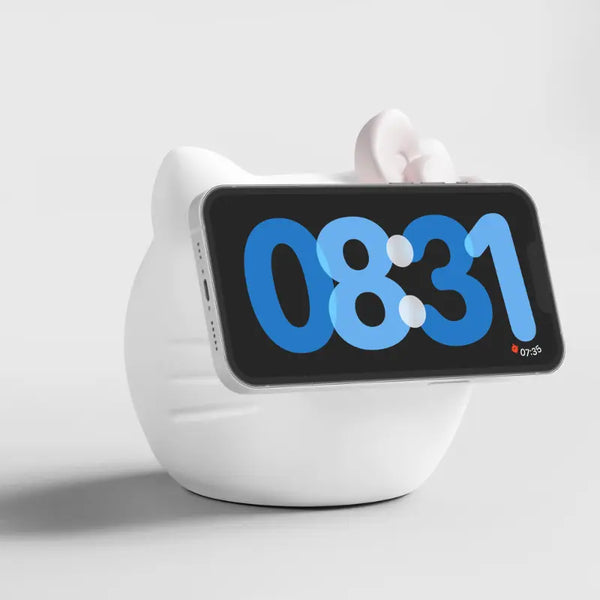 White cat-shaped phone holder with a pink bow, displaying a digital clock and time.