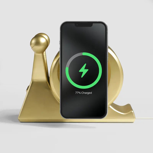 Gold snail-shaped wireless charger with a smartphone displaying charging status, by Craft Kittiesfr.