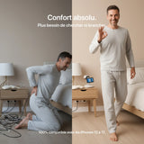 Gray loungewear set featuring a long-sleeve top and pants, model smiling in a cozy bedroom setting.