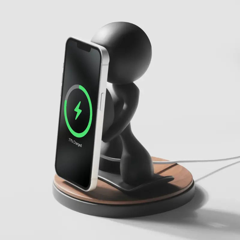 Black figurine phone stand with wireless charging capability and wooden base