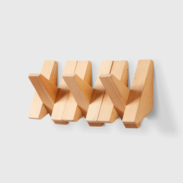 Wooden triangle wall hook in red oak and walnut by Frêne, featuring a minimalist design.