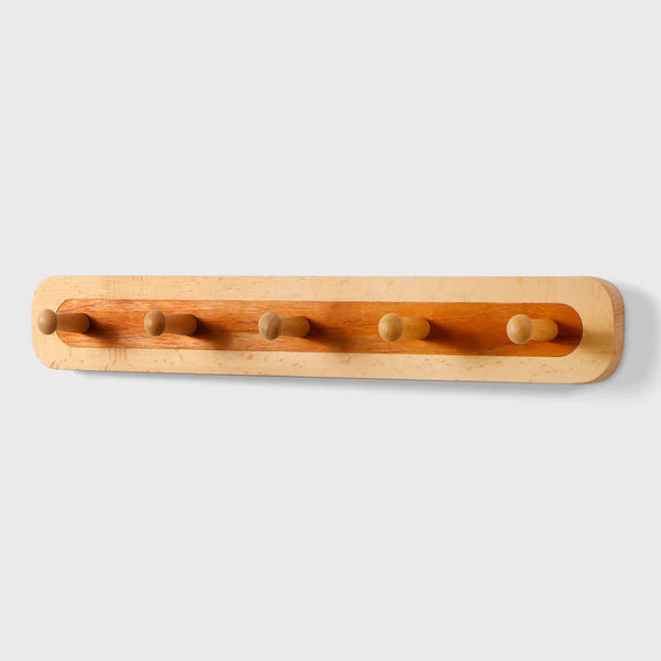 Wooden wall hook rack with five round pegs in light oak finish by Frêne.